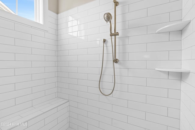 bathroom featuring tiled shower