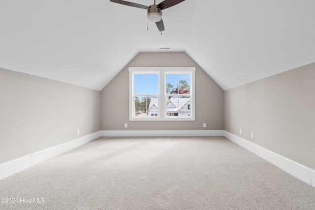 additional living space with ceiling fan, light carpet, and lofted ceiling