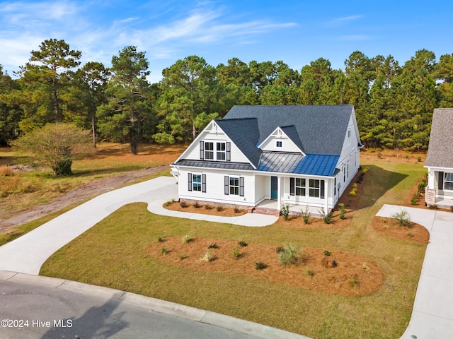 view of front of house with covered porch and a front yard