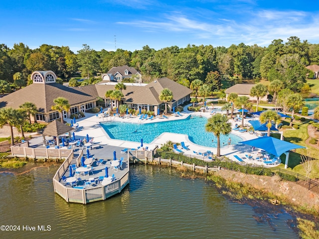 view of swimming pool with a patio area and a water view