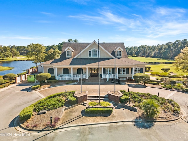 farmhouse inspired home featuring a porch and a water view