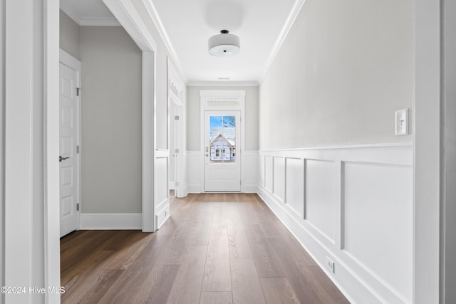 hallway featuring hardwood / wood-style floors and ornamental molding