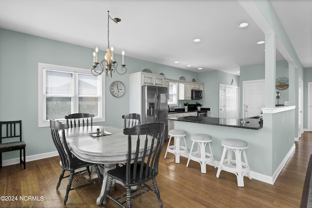 dining space featuring baseboards, a chandelier, dark wood-style flooring, and recessed lighting