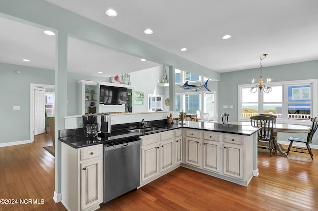 kitchen featuring recessed lighting, light wood-style flooring, a sink, dishwasher, and baseboards