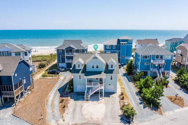 birds eye view of property with a beach view and a water view