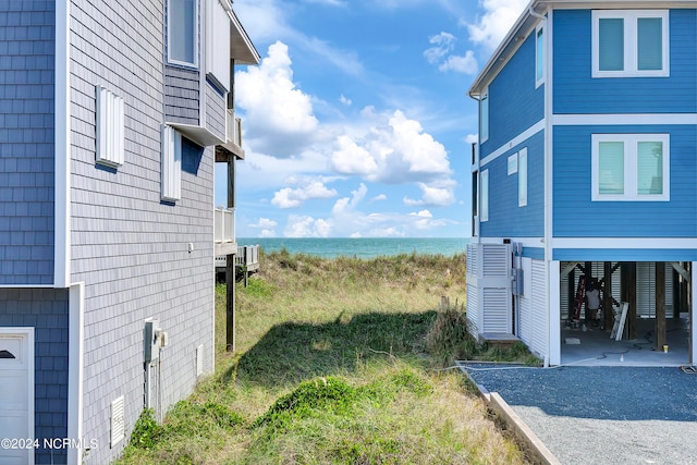 view of yard with central air condition unit and a water view