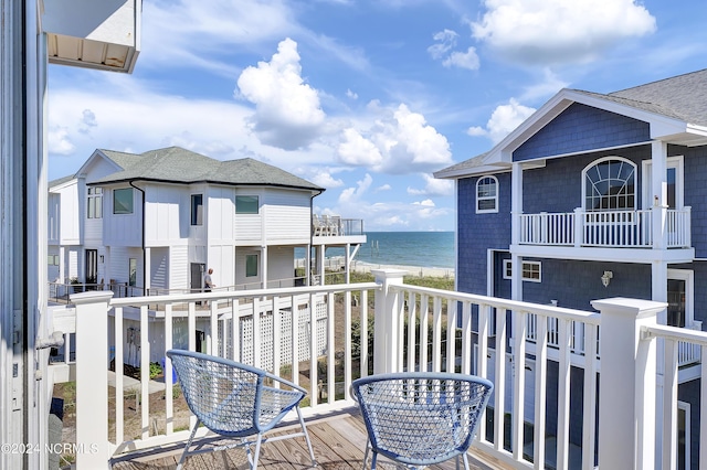 balcony featuring a water view and a view of the beach