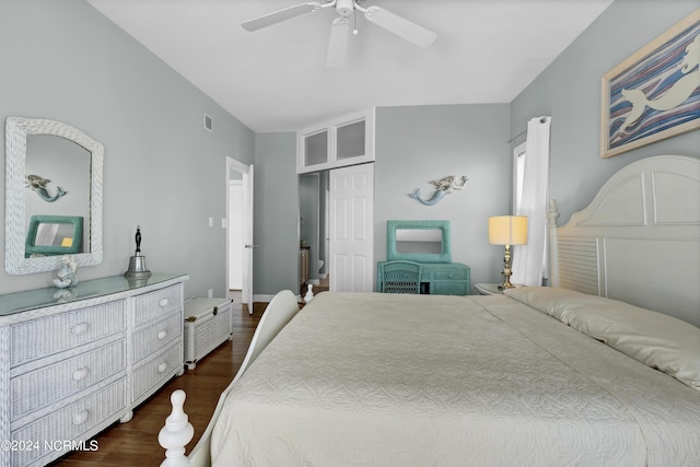 bedroom featuring dark wood-style floors, ceiling fan, a closet, and visible vents