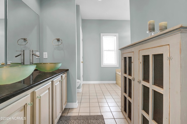 bathroom featuring tile patterned flooring, vanity, and toilet