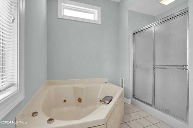 full bathroom with a jetted tub, a stall shower, and tile patterned floors