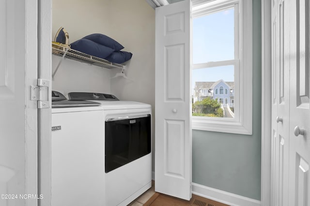 laundry area featuring laundry area, independent washer and dryer, and baseboards