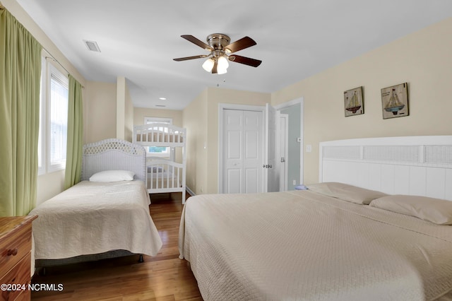 bedroom with ceiling fan, a closet, and hardwood / wood-style flooring