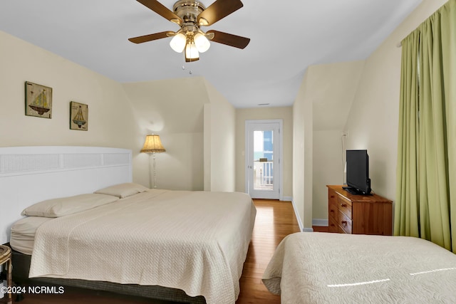 bedroom with access to exterior, ceiling fan, and hardwood / wood-style floors