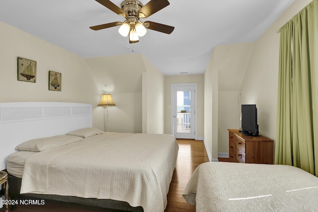 bedroom with wood finished floors, a ceiling fan, and baseboards