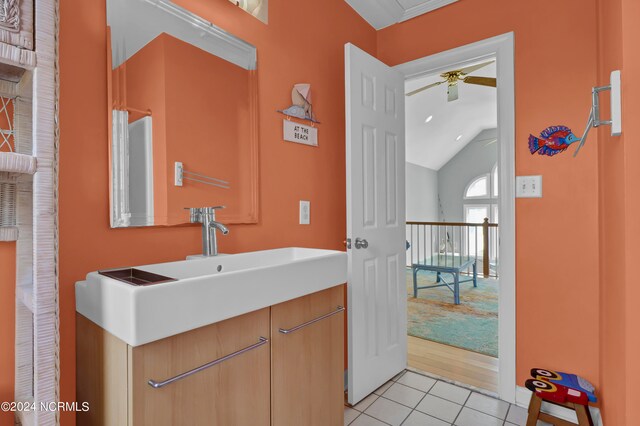 bathroom featuring lofted ceiling, vanity, ceiling fan, and tile patterned floors