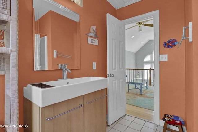 bathroom featuring tile patterned flooring, vaulted ceiling, ceiling fan, and vanity