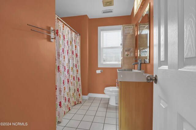 bathroom with vanity, toilet, a shower with shower curtain, and tile patterned floors