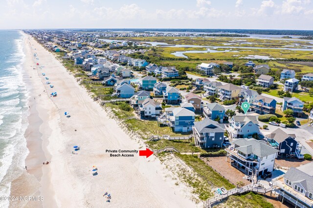 bird's eye view featuring a water view and a beach view