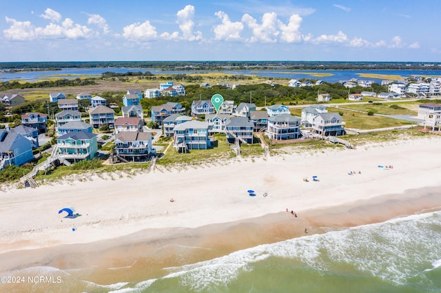 drone / aerial view with a water view and a beach view