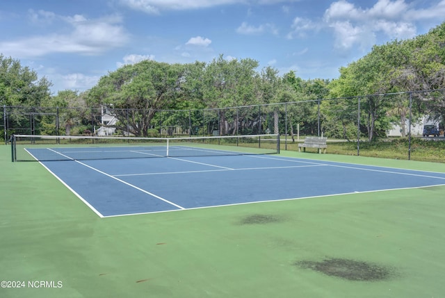 view of tennis court with fence