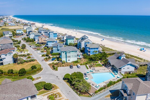 drone / aerial view with a beach view and a water view