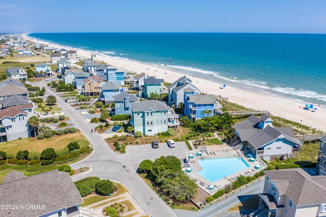 drone / aerial view featuring a water view, a residential view, and a view of the beach