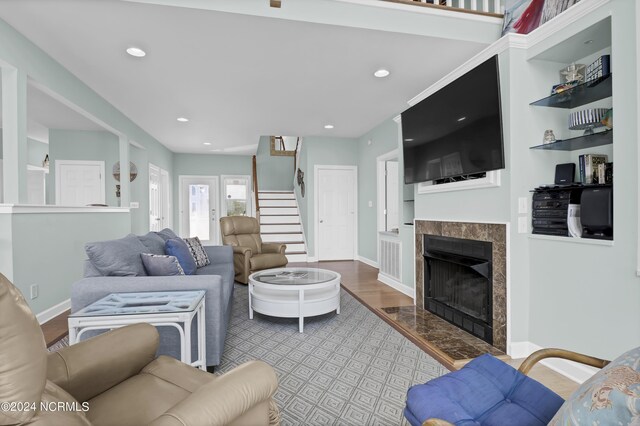 living room with light hardwood / wood-style floors and a tile fireplace