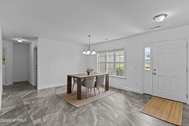 entryway featuring an inviting chandelier