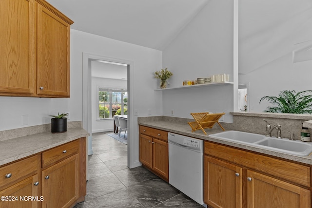 kitchen featuring white dishwasher, lofted ceiling, and sink