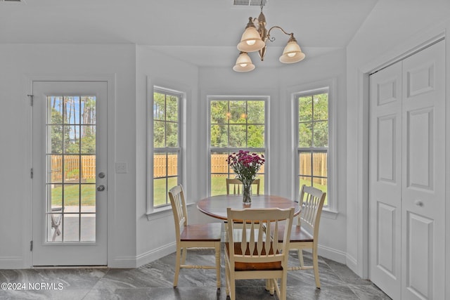 dining area with a notable chandelier and a wealth of natural light