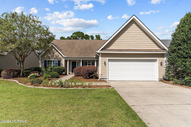 view of front of house with a front yard and a garage