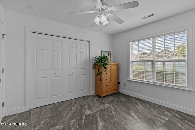 unfurnished bedroom featuring a closet and ceiling fan