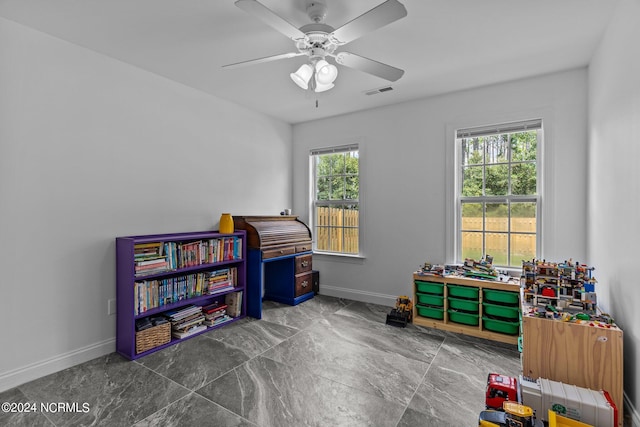 playroom featuring ceiling fan and a healthy amount of sunlight