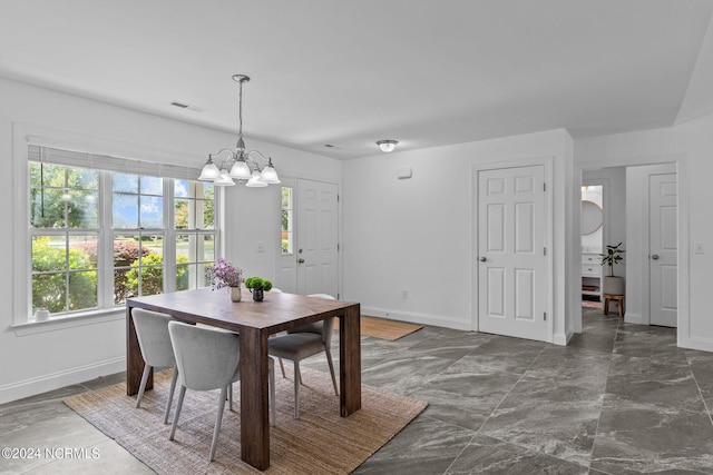 dining space with a chandelier