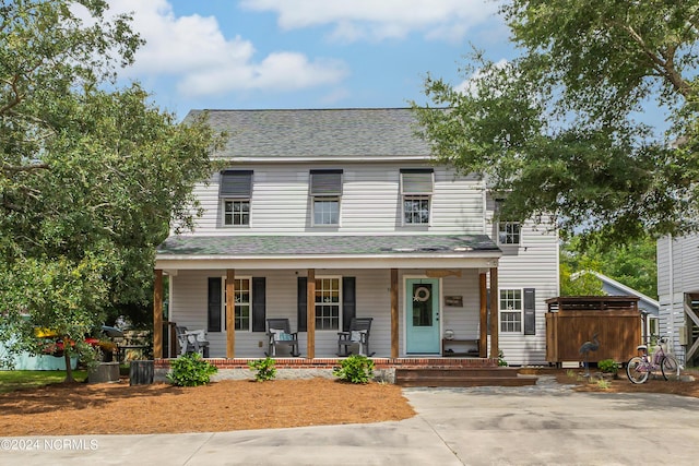 view of front of property with covered porch and roof with shingles