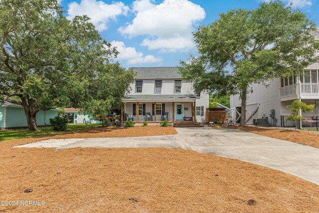 view of front of house with covered porch and central AC