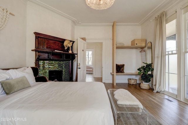 bedroom featuring crown molding, a notable chandelier, and hardwood / wood-style floors