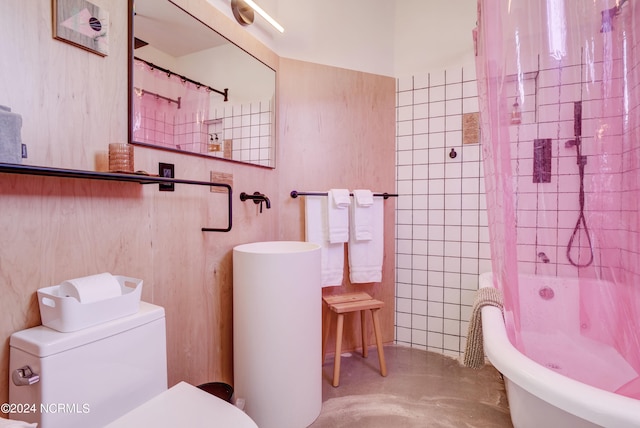 bathroom featuring toilet, shower / bath combination with curtain, and concrete flooring