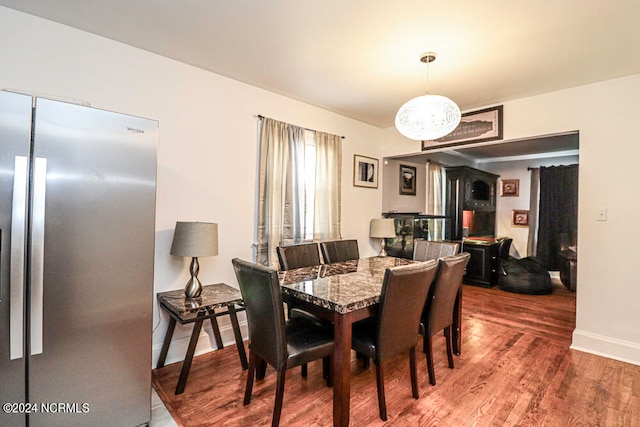 dining space with dark hardwood / wood-style flooring