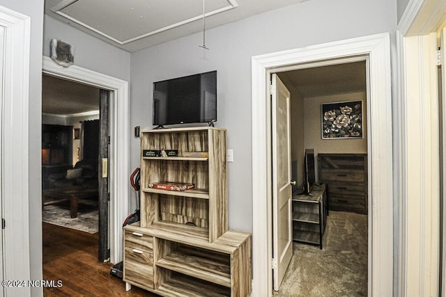 hall featuring attic access and wood finished floors