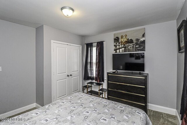 bedroom featuring a closet and baseboards