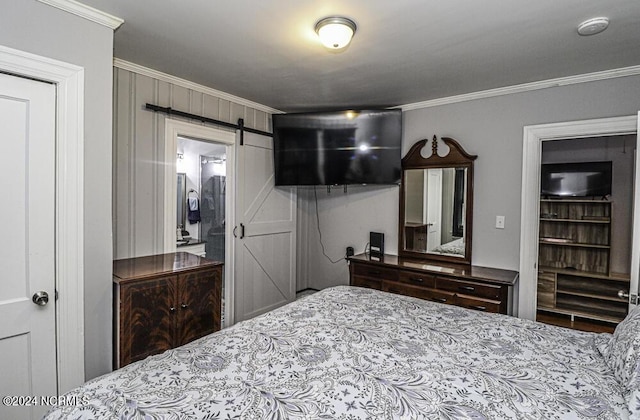 bedroom with a barn door and ornamental molding