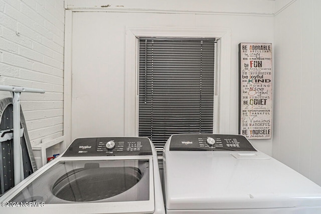 clothes washing area featuring washer and clothes dryer