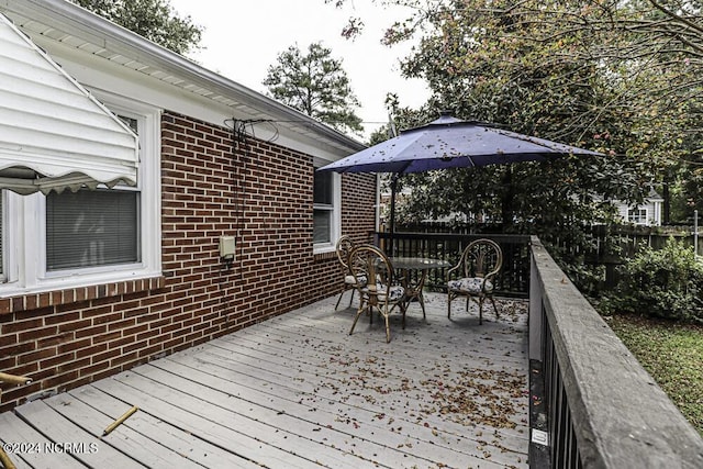 wooden deck with fence and outdoor dining space