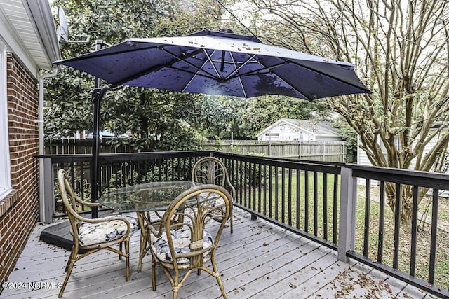 deck with a yard, a fenced backyard, and outdoor dining space