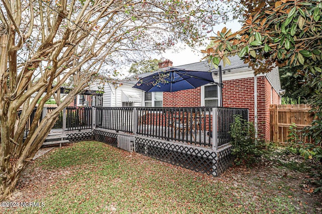 back of house featuring a wooden deck