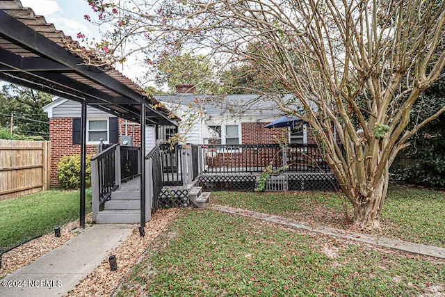 view of front facade featuring a front lawn and a pergola