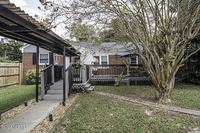 view of yard featuring fence and a wooden deck