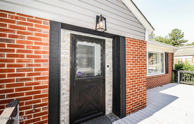 doorway to property featuring a wooden deck