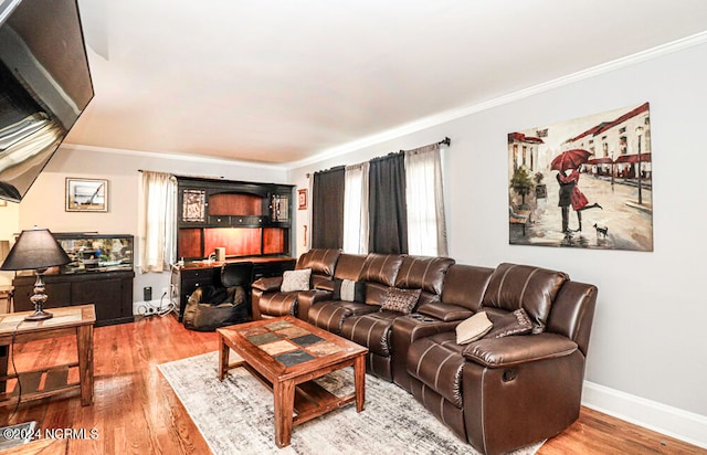 living room with crown molding and hardwood / wood-style flooring